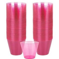 pink plastic cups are stacked on top of each other with one cup in the middle