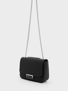 This product is made with at least 20% sustainable materials by weight. CHARLES & KEITH uses recycled, degradable, organic, and water-based materials in our eco-conscious collection. In versatile and timeless black, this chain strap shoulder bag will quickly become your go-to night-out bag. It will hold your phone, cards and must-have items with ease. Eye-catching silver chain straps give this modern and elegant piece an edgy, grunge-inspired aesthetic. To create a classic after-dark look, pair it with an all-black ensemble and a chic updo. Black Bag For Prom, Chic Updo, Edgy Grunge, Inspired Aesthetic, Dark Look, Phone Cards, Size Chart For Kids, Charles Keith, Must Have Items