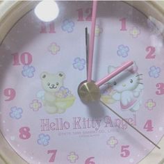 a clock with hello kitty and teddy bears on it's face is shown in this image