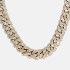 Make a lasting impression with the 13mm Iced-Out Cuban Link Chain, a bold and luxurious statement piece adorned with 41 carats of premium natural diamonds. Each diamond is graded G+ in color for radiant near-colorless brilliance and VS in clarity for exceptional purity. The diamonds are meticulously hand-set along the robust 13mm Cuban links, creating a dazzling iced-out finish that radiates elegance and sophistication. Crafted from durable 10k solid gold, available in yellow, white, or rose gol Luxury Diamond Chain Ring, Iced Out Cuban Link Diamond Necklace In White Gold, Luxury Gold Chain Necklace With Cubic Zirconia, Gold Iced Out Round Diamond Necklace, Luxury White Chain Link Necklace, Luxury Iced Out Necklaces, Luxury White Cuban Link Necklace, Luxury Rose Gold Cuban Link Chain Necklace, Luxury Cuban Link Cubic Zirconia Necklace