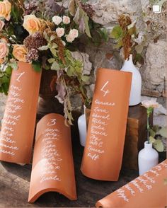 an arrangement of vases with flowers and calligraphy on them