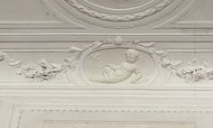 an ornately decorated ceiling with white paint