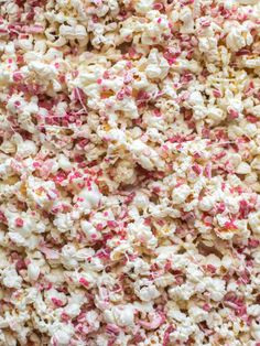 popcorn with sprinkles on it in a bowl