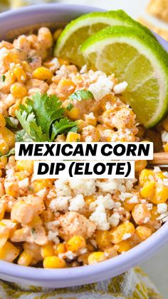 a bowl filled with corn, cheese and cilantro on top of a table