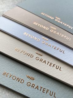 five metal business cards with the words beyond grateful written in gold and silver on them