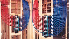 several red and blue hoses are connected to the inside of a wooden structure,