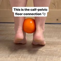 a person standing on the floor with an orange ball