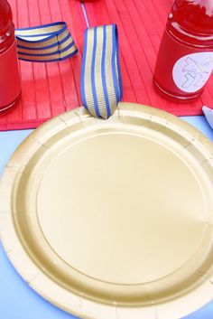 there is a paper plate on the table with red, white and blue napkins