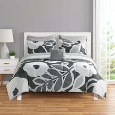 a bed in a room with a white and black comforter