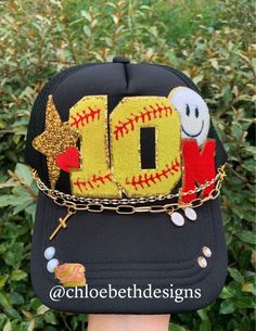 We can do any color hat you would like!! We can also replace baseball number patch with baseball, soccer, or basketball.  Hat chains are removable with clasps on each end. They can be bought separate or with the hat. Please allow up to 2 weeks for this hat to ship as this is a pre-order item.  $10-$12 chain options do not include hats.  $40-$50 bling hat options do include trucker hat and bling as pictured.  For clarification when purchasing: If you purchase one of the hat chain options, this is Cheap Sports Fan Hats For Sports Events, Cheap Customizable Sports Hats, Gold One Size Snapback Baseball Cap, Trendy Gold Baseball Cap One Size, Trendy Gold Baseball Cap, Fun Personalized Baseball Cap, Personalized Snapback Baseball Cap Fun Style, Fun Personalized Snapback Baseball Cap, Personalized Fun Snapback Baseball Cap