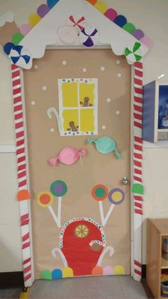 a decorated door in the shape of a house with candy canes and candies