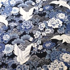 a blue and white fabric with flowers and birds on it