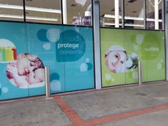 the storefronts are decorated with advertisements for baby products