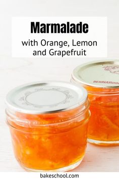 two jars filled with orange lemon and grape marmalade on top of a white table