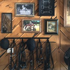 there are many pictures on the wall with horse tacks and hats hanging from it