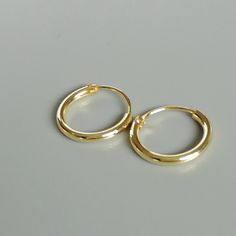 12mm sterling silver endless ear hoops, dipped in gold. Size: 1.5 x 12 mm These earrings are made of real 925 hypoallergenic sterling silver, dipped in real gold. Will be packaged in a gift box. Please let me know if you don't want it in one. I can write out a message from you to the receiver if needed. Please be free to contact me at... bhavnakwintra1956@gmail.com More hoops: https://www.etsy.com/your/shops/TheSilverGame/tools/listings/section:26305414 More earrings: https://www.etsy.com/your/s Minimalist Nickel-free Small Hoop Huggie Earrings, Small Hoop Huggie Earrings For Gift, Simple Hoop Huggie Earrings For Everyday, Minimalist Tarnish Resistant Ring, Simple Nickel Free Small Hoop Huggie Earrings, Nickel-free Minimalist Hoop Huggie Earrings, Minimalist Adjustable Small Hoop Huggie Earrings, Simple Hoop Huggie Earrings As Gift, Minimalist Hoop Huggie Earrings With Simple Design