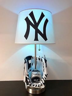 a lamp that has a baseball glove on it and a new york yankees ball in front of it