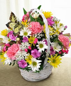 a basket filled with lots of colorful flowers