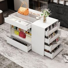 a white table with drawers and purses on it