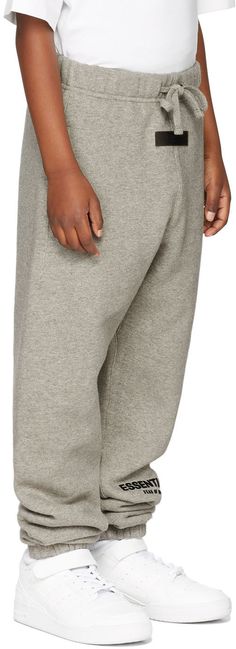 Relaxed-fit cotton-blend fleece lounge pants in gray. Logo flocked in black at front. · Mid-rise · Two-pocket styling · Drawstring at elasticized waistband · Elasticized cuffs · Hand wash Model measures 48 / 122 cm tall and wears size S. Part of The Core Collection. Please note that this item may not be shipped within the EU. Supplier color: Dark oatmeal Size: child's height XXS: 36-41 / 91.5-104 cm XS: 41-44.5 / 104-113 cm S: 44.5-48.5 / 113-123 cm M: 48.5-53 / 123-134.5 cm L: 53-58 / 134.5-147 Fear Of God Essentials, Fear Of God, Lounge Pants, Kids Clothing, Mid Rise, Kids Shop, Kids Outfits, Cotton Blend, Lounge