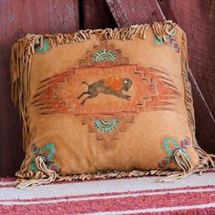 a decorative pillow with a dog on it sitting next to a wooden door and rug