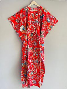 "This Beautiful Indian Cotton Caftan Or Can Be Called As Tunic Is Made With Super Fine Quality Cotton And Designs Have Been Crafted By Hand Prints. Measurements :- Size - Free Size Length -138 Cm / 54 Inches Bust/Chest Size - 87 CM/ 34 Inches Fabric - 100% Cotton Pattern - Floral Kaftan Has Adjustable Drawstring Waist To Loose Or Tight , Kaftan Has V Shape Neck Which Is 8\" Inches Deep. Kaftan Is Multi-Purpose And Can Be Worn As A Cover Up At The Beach ,Lounge Wear ,Sleepwear ,Pregnant Women Hos Red Cotton Kimono For Vacation, Red Cotton Short Sleeve Kaftan, Red Cotton Robe With Kimono Sleeves, Red Cotton Kaftan For Spring, Free Size Red Short Sleeve Kaftan, Red Short Sleeve Free Size Kaftan, Traditional Red Printed Kimono, Red Cotton Kimono For Festival, Traditional Red Kimono For Summer