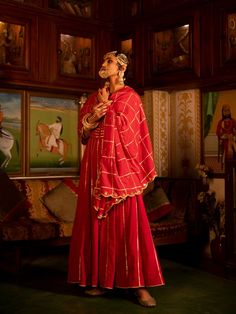 Enter the world of luxurious & regal clothing with Sahiba. Celebrate the grandeur of beauty, celebrations, dressing up and womanhood with vintage textiles and silhouettes. Set of 3 consists of Kalidar, pajama and dupatta. Kurta: A red ghera cotton kalidar is adorned with heavy gold gota work on neck and kalis. Dupatta: A handspun mul red dupatta is detailed with zari and mirror scallop detailing with heavy gota chaukadi work Bottom: Red Farshi pajama is detailed with pure metal gold lampi. Mater Red Dupatta, Gota Work, Vintage Textiles, Anarkali, Victorian Dress, Dress Up, Saree, Textiles, Pure Products