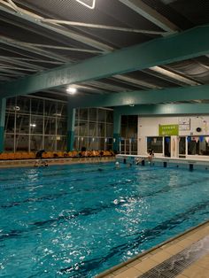 an indoor swimming pool with people in it