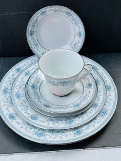 a stack of blue and white china plates