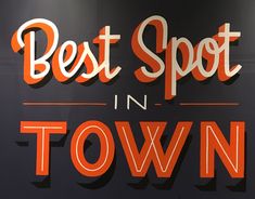 the sign for best spot in town is displayed on the side of a building with an orange and white lettering