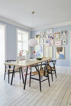 an image of a dining room setting with pictures on the wall