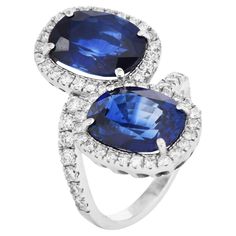 Discover the exquisite beauty of this Vintage Sapphire and Diamond Halo Bypass Engagement Ring. Perfect for those who cherish sophisticated elegance with a splash of vibrant color, this ring is an unforgettable choice for a proposal. Luxurious jewelry design. This ring features two natural Virbant blue oval sapphires, both sapphires are from Madagascar, totaling approximately 10.88 carats, encircled by a halo of 61 natural round diamonds. Sapphire measures approximately 11.77mm x 9.16mm x 5.54mm and weighs 5.29 carats  the other measures 11.9mm x 8.95mmx 5.55mm and 5.59 carats each surrounded by round diamonds, approximately 1.83 carats VS clarity, G-H color, set in premium platinum. The beautiful bypass style on an accent band is a statement ring, sized at 6.75(sizable). Two GIA Lab Repor Bypass Engagement Ring, Luxurious Jewelry, Colored Stone Rings, Vintage Sapphire, Gem Stone, Diamond Halo, Crystals Minerals, Sapphire Diamond, Cocktail Rings