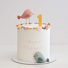 a birthday cake with a bird on top