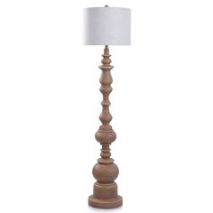 a wooden floor lamp with a white shade