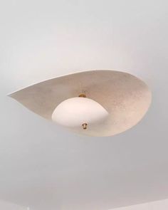 a white ceiling light hanging from the ceiling in a room with no one around it