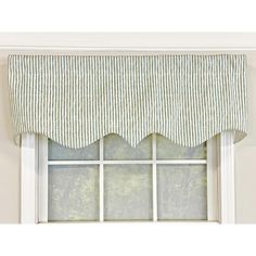 a window with a green and white striped valance