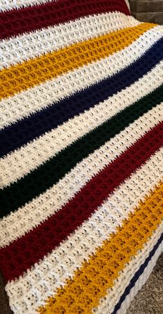 a crocheted blanket sitting on top of a couch