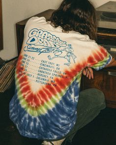 a person sitting in front of a record player