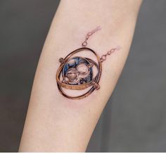 a tattoo on the arm of a woman with a clock in it's center