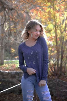 "*CLEARANCE PRICING!*  Cozy up outdoors in this ultra-comfortable women's graphic long-sleeve shirt! Equal parts functional and fashionable, this heavenly soft, relaxed-fit pullover is perfect for cooler weather and evenings. It's comfortable enough to wear camping, but nice enough to wear out-and-about. The shirt is \"Eco True Navy,\" and the W-I-L-D crossed arrows design is screen-printed by hand in Silver glitter ink on front.  >> Additional item detail is below. Thank you for visiting Live a Wild Life! COLOR & SIZE: *Shirt color is Eco True Navy  *Sizes S, M, L, XL (size detail below) *Ink color is Silver glitter *Ink is water-based and eco-friendly ITEM DETAIL: *50% polyester, 38% cotton (6.25% organic), 12% rayon *Ladies' relaxed fit *Yarn-dyed and fabric-washed *Wide crewneck *Ragla Blue Tops For Fall Outdoor Activities, Casual Tops For Outdoor Fall Activities, Casual Tops For Fall Outdoor Activities, Casual Long Sleeve Tops For Outdoor Activities, Casual Fall Tops For Outdoor Activities, Casual Long Sleeve Tops For Outdoor, Relaxed Fit Long Sleeve Tops For Outdoor, Long Sleeve T-shirt With Letter Print For Outdoor, Spring Long Sleeve T-shirt With Text Print