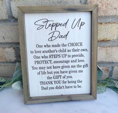 a wooden framed sign with the words, stepped up dad written in cursive writing