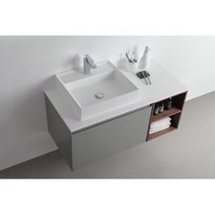 a bathroom sink with two faucets on the side and one cabinet below it