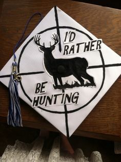 a white and black graduation cap with the words i'd rather be hunting on it