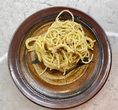 a bowl filled with pasta on top of a table