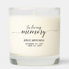 a white candle with the words i'm loving memory printed on it