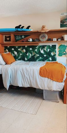 a bed sitting in a bedroom next to a shelf with surfboards on top of it