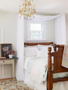 a bedroom with white bedding and a chandelier