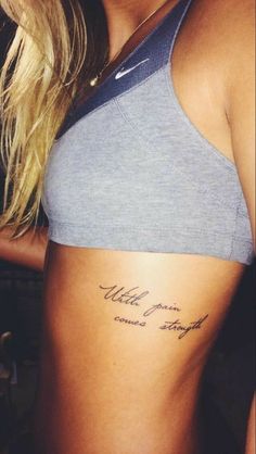 a woman with a tattoo on her stomach that says,'little town comes straight ahead '