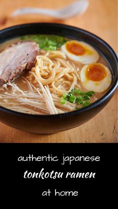 a bowl of ramen with noodles, meat and eggs in it on a wooden table