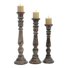 three wooden candlesticks sitting next to each other